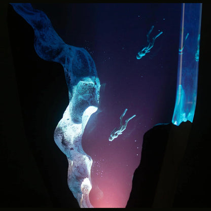 Double Dive resin lamp glowing in the dark, divers sinking into a blue abyss – Woodiny