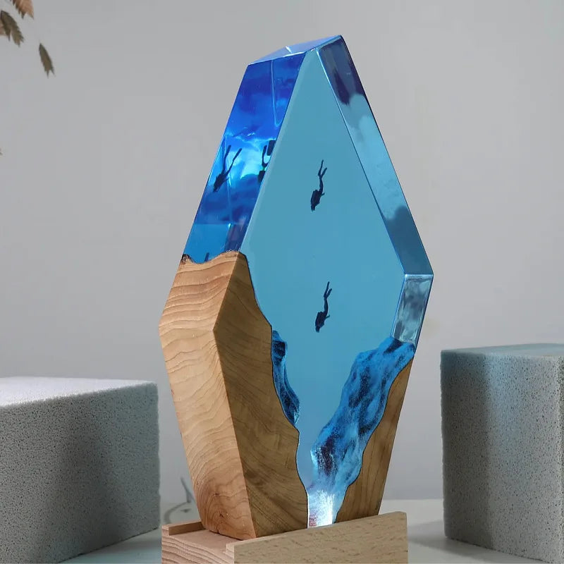 Two scuba divers descending into a wooden canyon inside blue epoxy resin – Woodiny