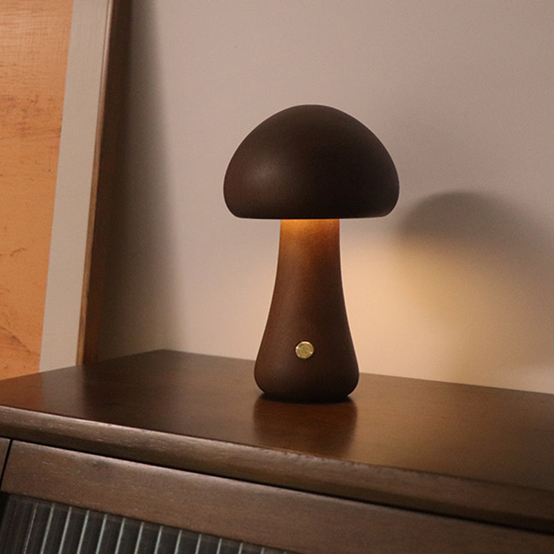 Dark wood mushroom night lamp with warm glow on a dresser – Woodiny