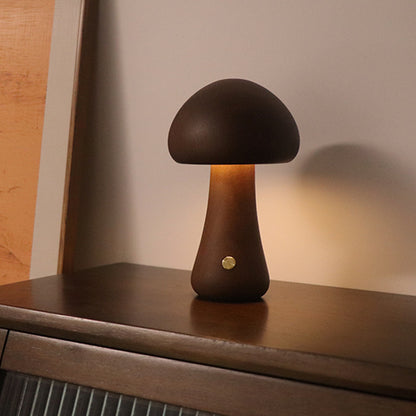Dark wood mushroom night lamp with warm glow on a dresser – Woodiny