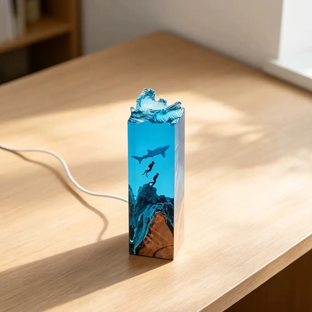 Spotted whale shark and scuba diver silhouettes sealed in clear epoxy resin, detail view